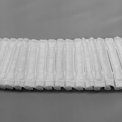 A close up of the back of 2 inch hook compatible curtain tape showing the soft loops ready to be attached to hook tape