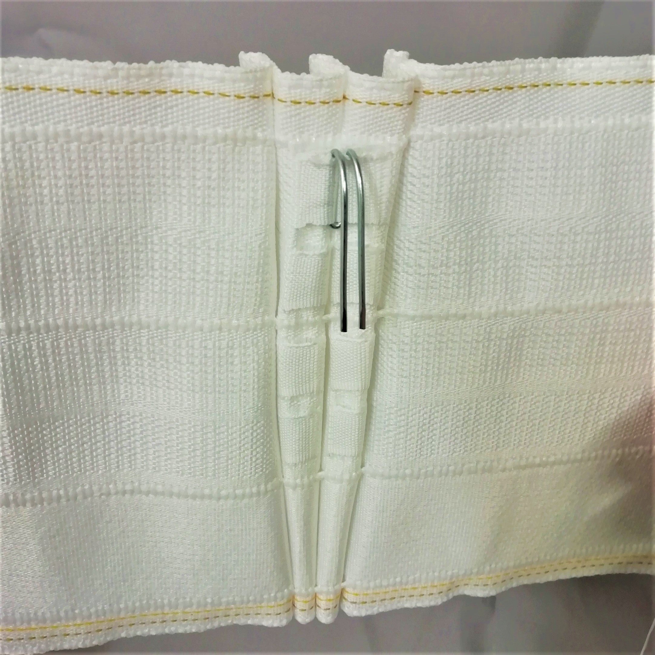 close up showing the curtain hook position on 6 inch pinch pleat curtain tape