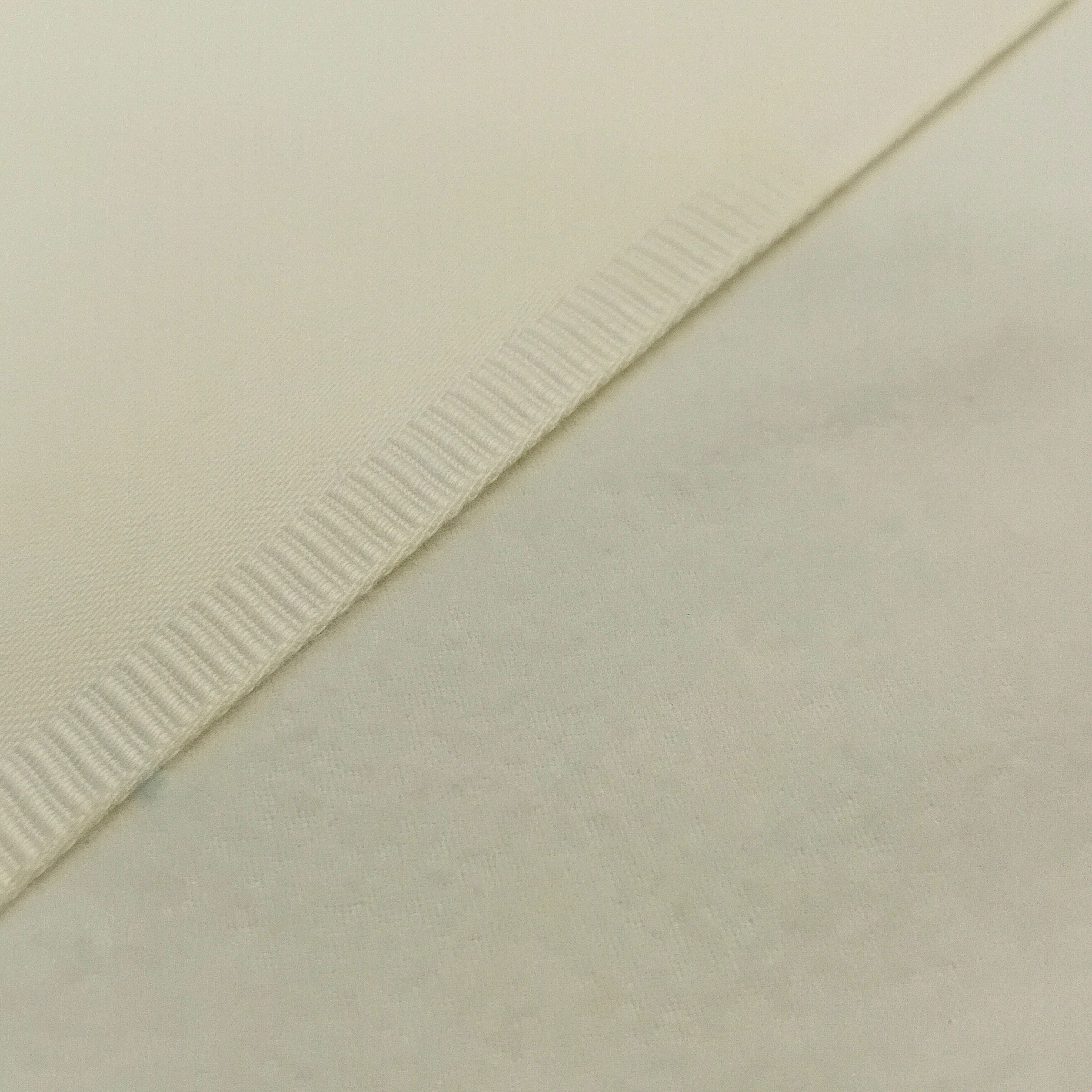 A close up of the two sides of brushed lining. One sateen one soft brushed