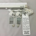 Roman blind headrail kit with brackets, screws child safety items and safety information label on a gray background