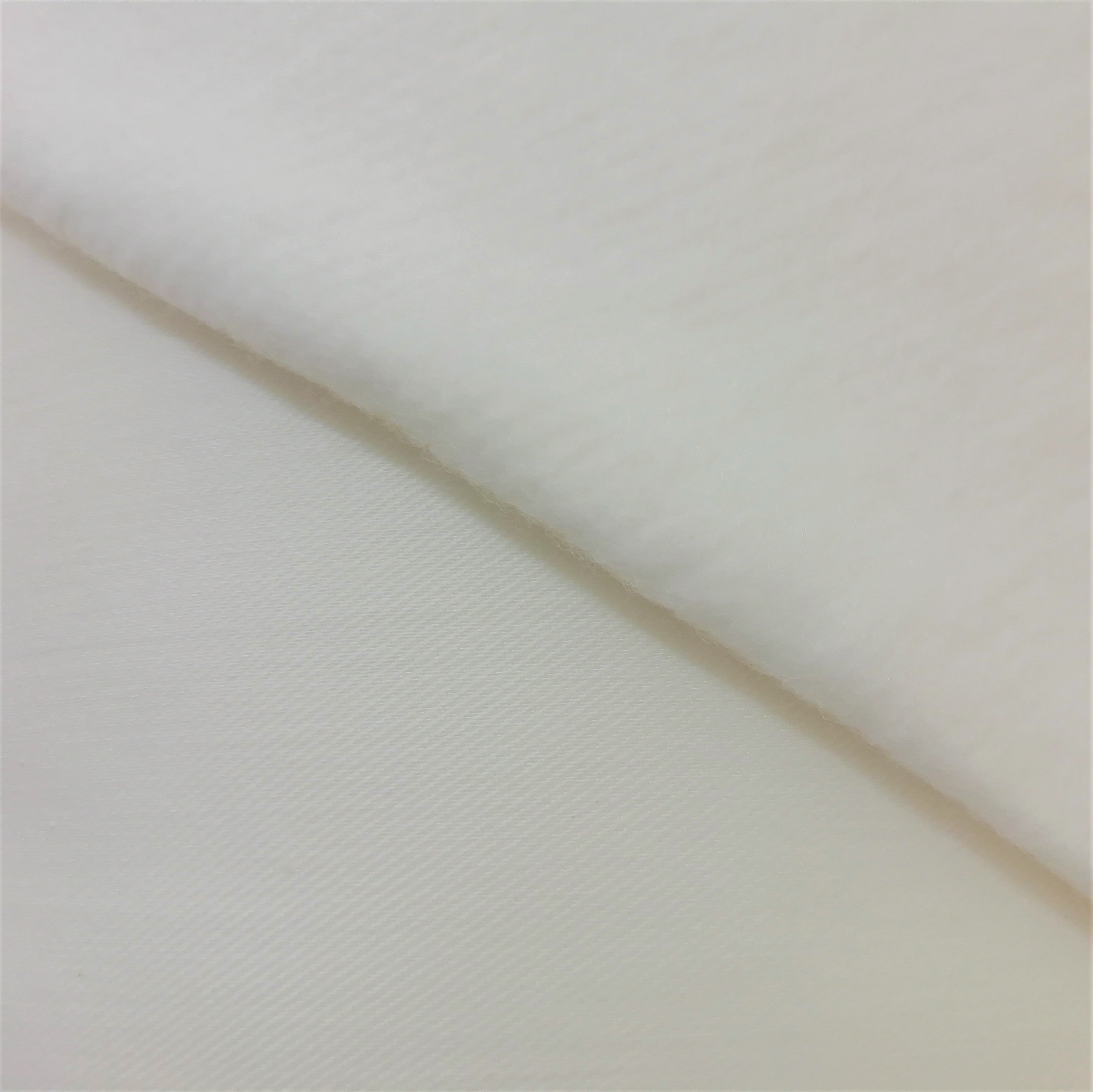 close up of bonded lining. ivory polycotton lining with fleece backing