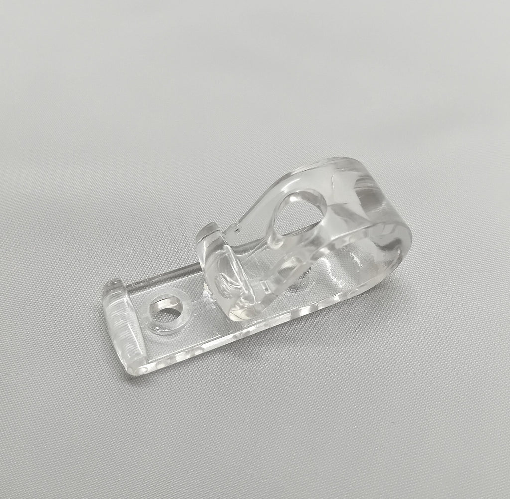 A P shaped chain clip. Clear pastic for securing chains to walls