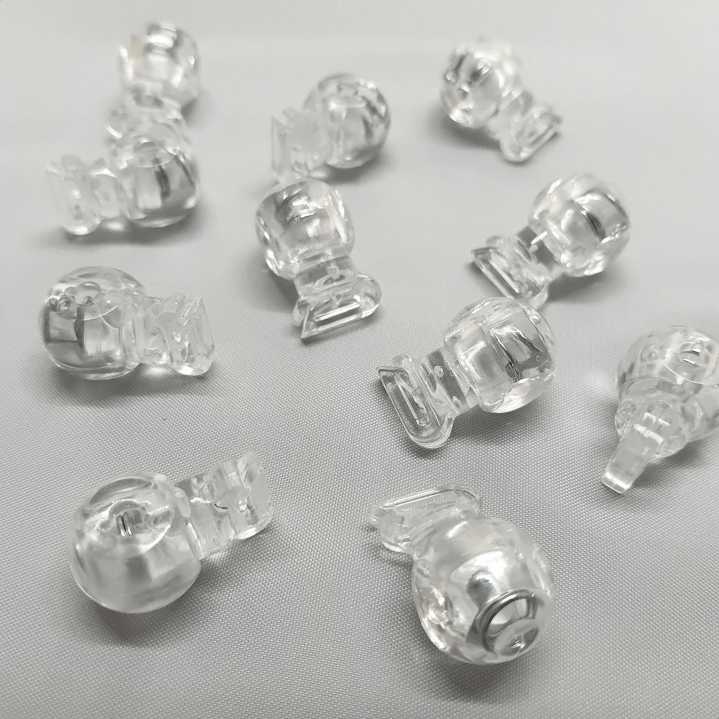 Lots of clear plastic cord stops