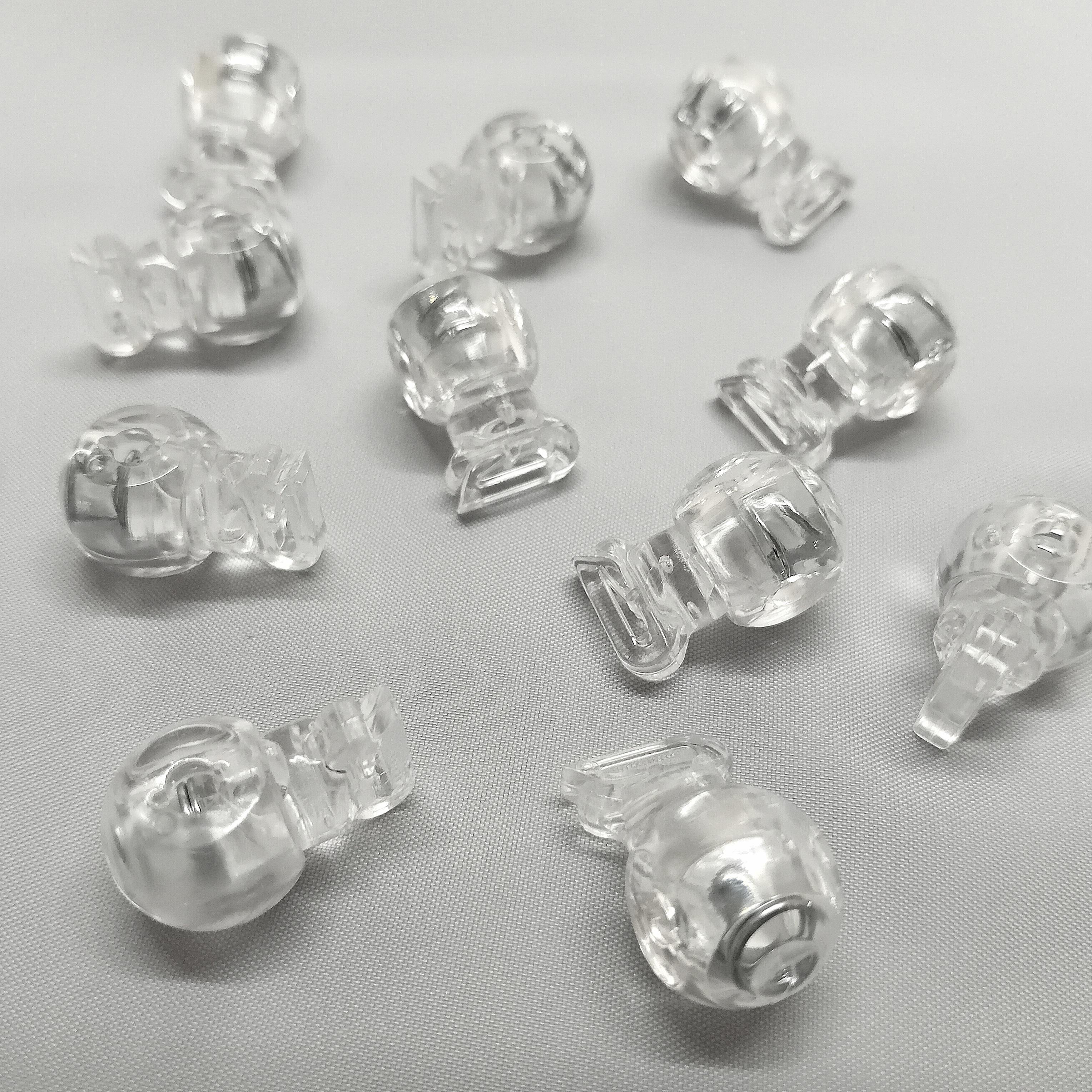 Lots of clear plastic cord stops