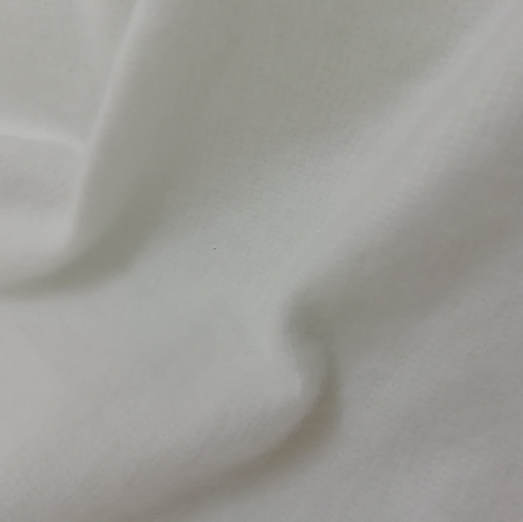 Close up of white medium weight polyester interlining
