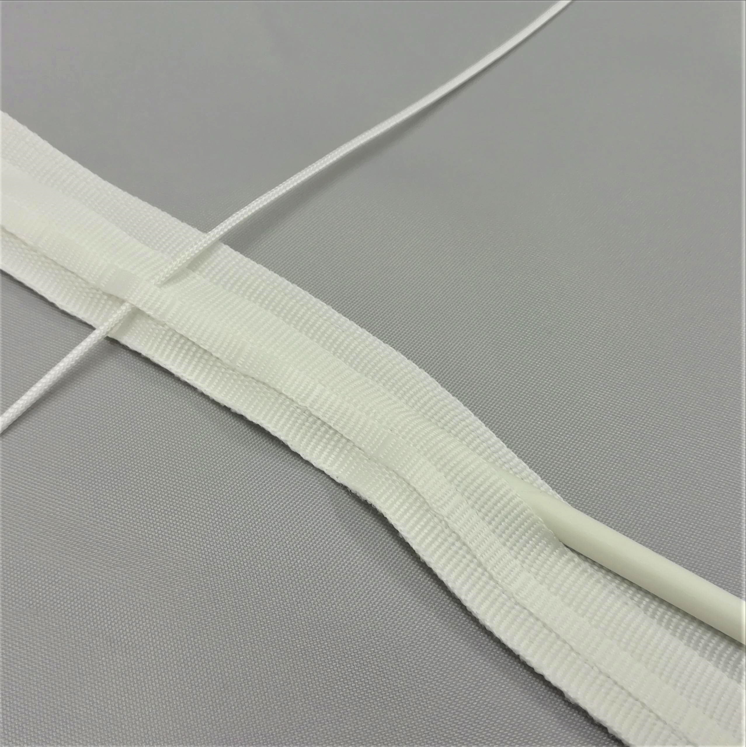 A close up of roman blind tape showing the rod going through slot into the tape pocket and cord going through the cord guide strip