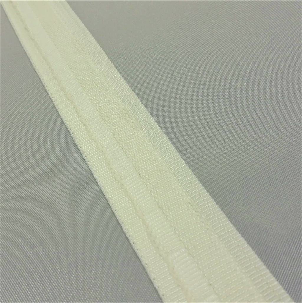 A close up of ivory roman blind tape